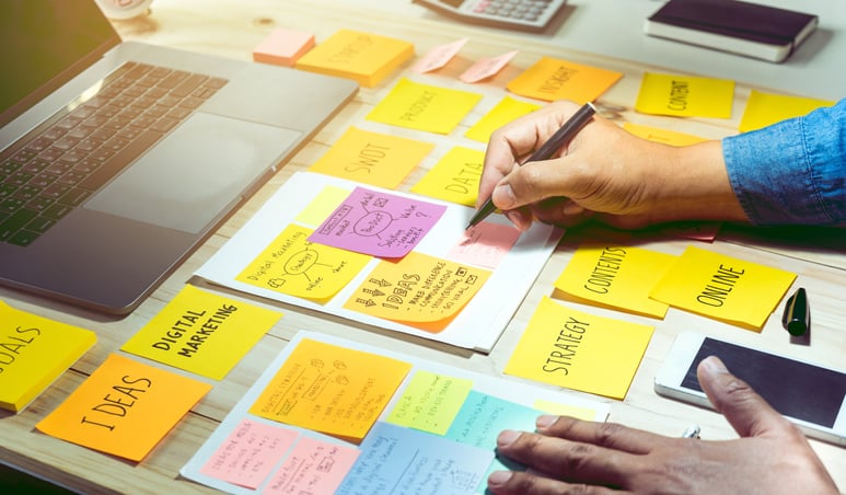 Businessman working with notepaper of brainstorming and communication marketing plan concepts